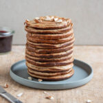 A stack of high-protein pancakes made of buckwheat, spelt, cooked soybeans, dates, oat milk.