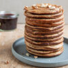 A stack of high-protein pancakes made of buckwheat, spelt, cooked soybeans, dates, oat milk.